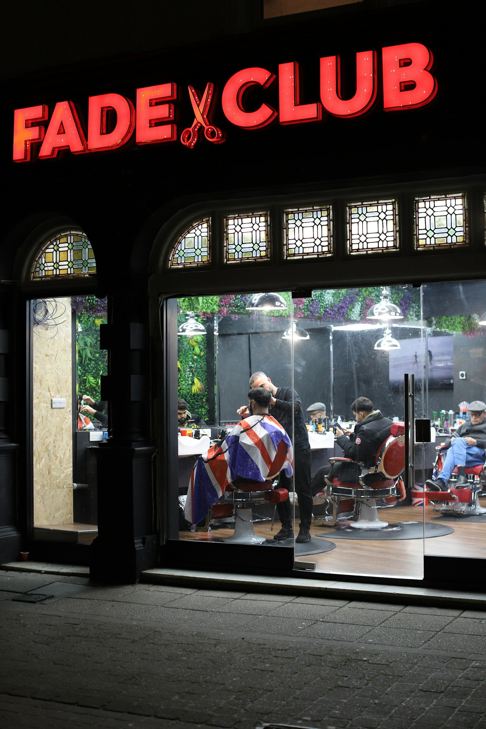 Barber providing a friendly haircut service in the salon